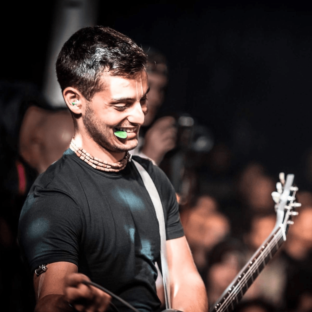 Madhu playing guitar on stage